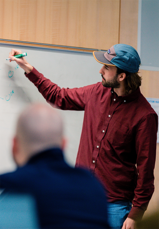 Teacher standing in front of class.