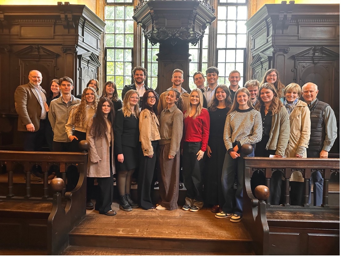 Students standing on a rostrum at Oxford