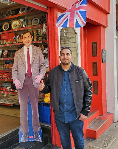 Mokhtar poses with Mr. Bean cutout in London shop